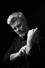 Portrait of handsome man on dark background. Black and white effect