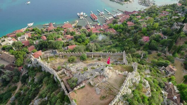 antalya kekova kalekoy castle aerial drone video turquoise blue sea cloudy sky settlement port and peninsula