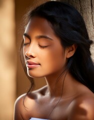 Naklejka premium A portrait of a woman with a serene expression, eyes gently closed, basking in sunlight. 