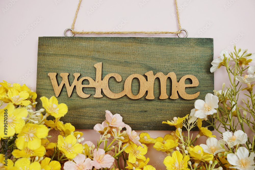 Wall mural Welcome Sign with flowers frame decorate on pink background