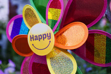 A colorful pinwheel with happy on the front