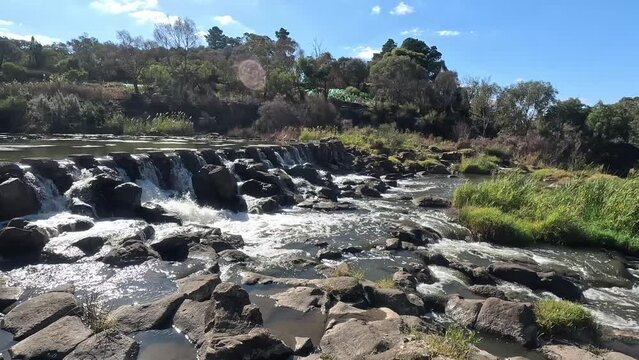 Rocky water cascade and river crossing at Buckley Falls Weir at the Buckley Falls Nature Reserve. Geelong, VIC Australia.