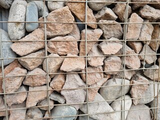 Cobblestones behind a metal mesh