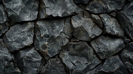A dark textured surface of interlocked rugged stone