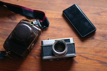Analog camera and smartphone: old and new technology.