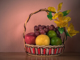 Fruits Basket on wooden table with wall concrete background, Still Light