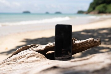 Smart phone on the beach. Mock up image 