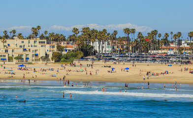 Huntington Beach with snow capped mountains in the distance, Orange County, California USA	