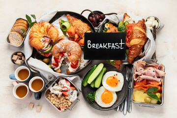 Large selection of breakfast food on a table.