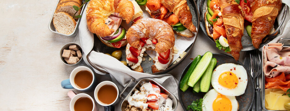 Large selection of breakfast food on a table.