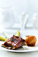 Fried pork ribs with potato dumplings on bright background. Close up.	
