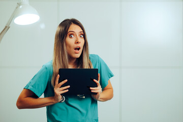 Surprised Doctor Holding a Pc Tablet Giving Diagnoses. Medical professional finding out shocking...