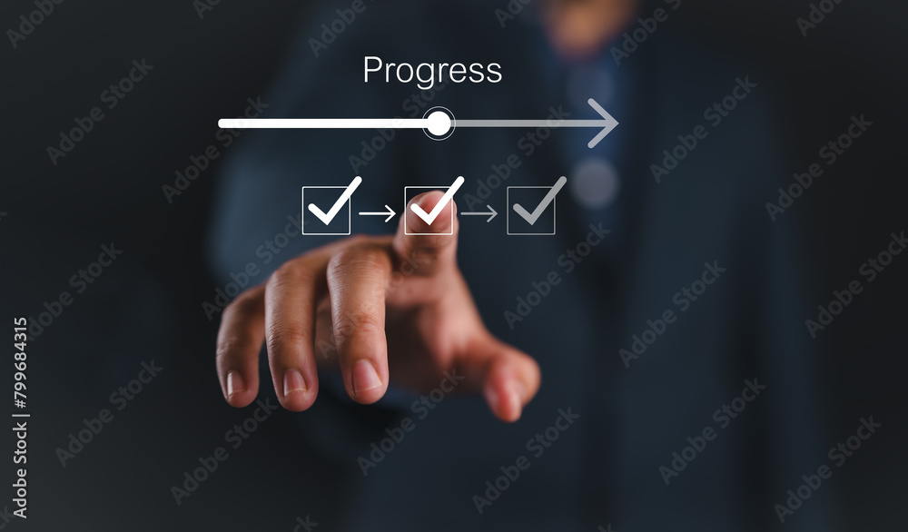 Fototapete Businessman or manager touching on checklist to tick correct mark with progressive loading status to remind work task progressive for project develop management and tracking concept.