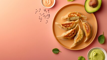 Flat lay gyoza with sauce, avocado slice and leaf copy space isolated