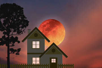 Small country house with silhouette big tree and big blood moon on dramatic colorful twilight sky.