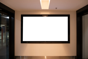 A blank white mockup background texture of an electronic and digital screen in the foyer at the entrance of an underground or indoor car park. Empty advertisement or information copy space.