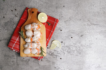 Raw Fresh Scallops on Wooden Board Isolated On Gray Background 