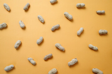 Peanuts Arranged on Yellow Background 