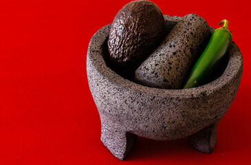 Mexican molcajete with chili and avocado.