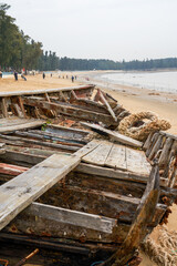Close-up of abandoned wooden boat on the beach by the sea