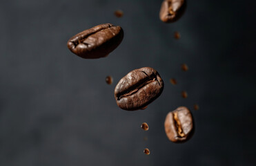 Fototapeta premium Coffee bean flying in the air in dark background
