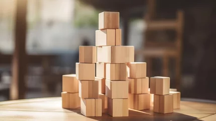 Fotobehang Soft focus on a wooden house model behind a stack of cube blocks on a rustic table, emphasizing real estate planning © reels
