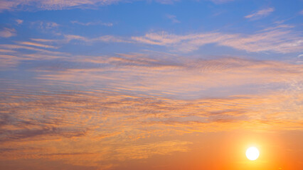 Sunrise sky with many orange clouds and yellow sunlight on horizon sky background in the morning,...
