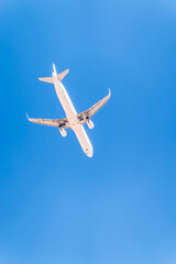 Airplane before landing in blue sky, Airbus A321-200