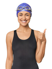 Young Caucasian female professional swimmer smiling and raising thumb up