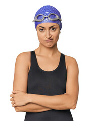 Young Caucasian female professional swimmer unhappy looking in camera with sarcastic expression.
