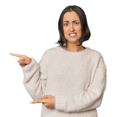 Young Caucasian woman with short hair shocked pointing with index fingers to a copy space.