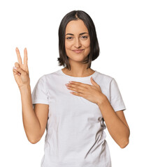 Young Caucasian woman with short hair taking an oath, putting hand on chest.