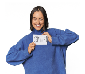 Young Caucasian woman holding "smile" sign in studio