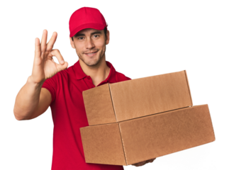 Young Hispanic delivery man with boxes cheerful and confident showing ok gesture.
