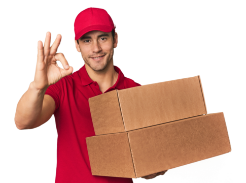 Young Hispanic delivery man with boxes cheerful and confident showing ok gesture.