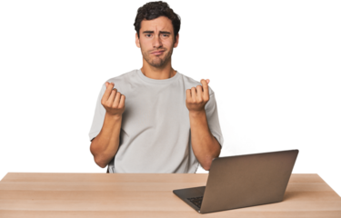 Hispanic young man working on laptop showing that she has no money.