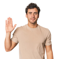 Young Hispanic man in studio smiling cheerful showing number five with fingers.