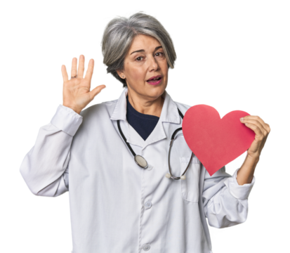 Caucasian mid-age doctor with heart symbol smiling cheerful showing number five with fingers.