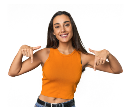 Hispanic young woman points down with fingers, positive feeling.