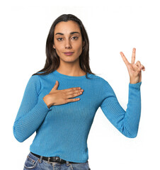 Hispanic young woman taking an oath, putting hand on chest.