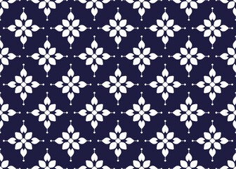 Fototapeta premium White symbol flowers form on dark blue background, ethnic fabric seamless pattern design for cloth, carpet, batik, wallpaper, wrapping etc.