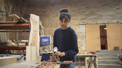 Woman carpenter planing wood block. Feminist girl process timber bar. Male carpentry work. Female...