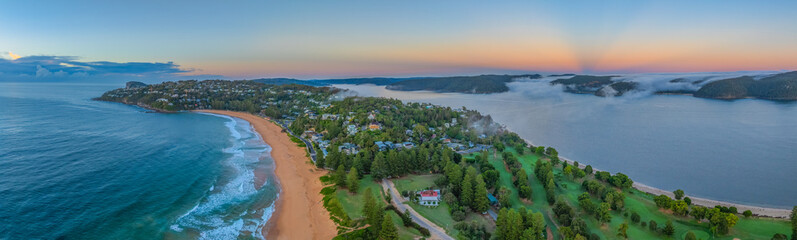 Sunrise over the sea with a low cloud bank and fog