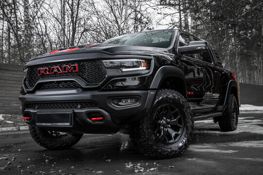 Novosibirsk, Russia -  April 04 , 2024: Black and   Red  Dodge Ram Trx,  parked of a city. No other car and people,  front view