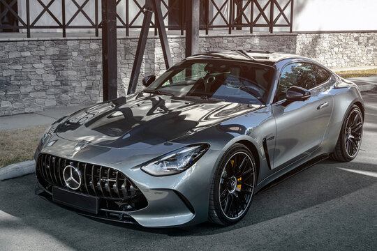 Novosibirsk, Russia - April    23,  2024 : silver  Mercedes-Benz  AMG GT 63 S 4MATIC    parked  against the backdrop of   city