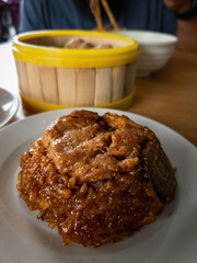 Glutinous rice with soy sauce cooked together with chicken parts and eat with chop stick.