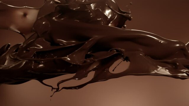 Super Slow Motion Shot of Chocolate Splashes Flying Towards and Crashing at 1000 fps.