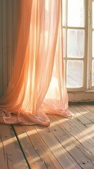 peach curtain hanging beside a window in a room with wooden flooring. 