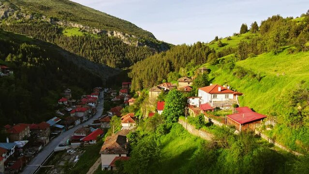 Quick Flight Behind a House Accend to Reveal Massive Hills Hidden Village Sunset