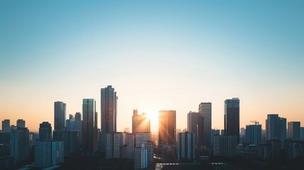 Fototapeta premium Sunrise and a new day over the city. Skyscraper silhouettes.